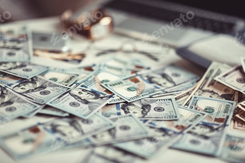 Preview: Top view mobile device and glasses on different US dollars bills background at natural light
