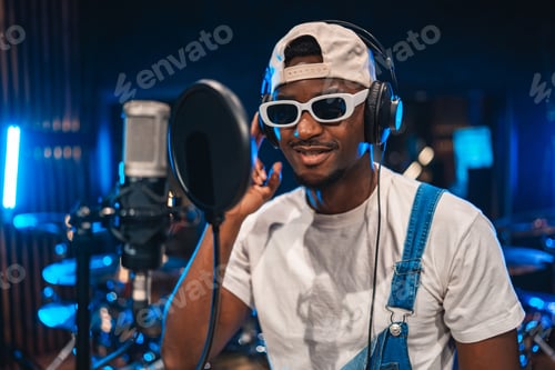 Preview: Young male singer recording new hit song in professional studio