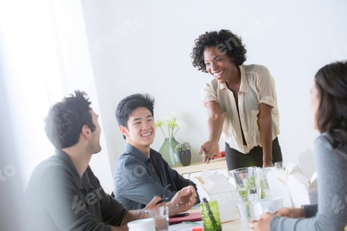 Preview: Colleagues enjoy a lighthearted moment during a lunch meeting.