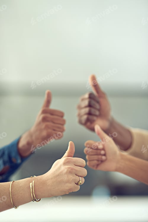 Preview: Youre doing great. Closeup shot of a group of businesspeople giving thumbs up together.