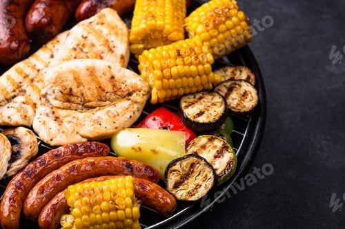 Preview: Grilled sausages, meat, and vegetables.