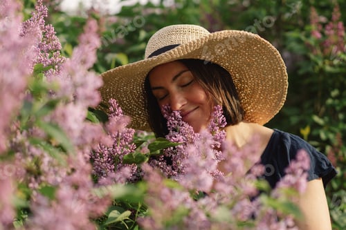 Preview: Portrait of a beautiful woman with fashionable bob hair in a lilac garden.