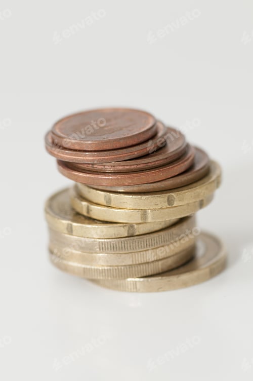 Preview: Stack of euro and euro cent coins on the gray background, the concept of savings