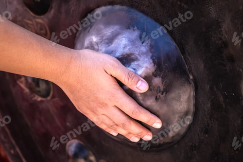 Preview: View of hand touch and scrub at the gong or temple big round bell or Thai traditional instrument
