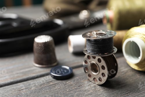 Preview: Bobbins with threads on table. Tailoring accessories