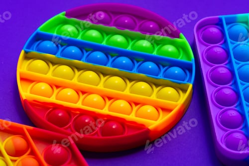 Preview: Colorful antistress pop it toy on purple background