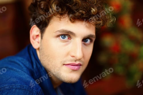 Preview: Closeup portrait of a young handsome man with curly hair