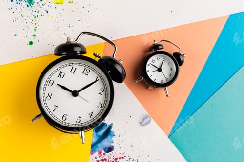 Preview: Vintage black alarm clock on a color block background