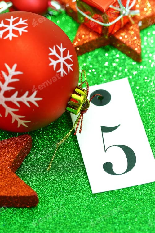 Preview: Number Five On Tag And Christmas Ornamets On Green Background