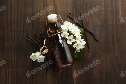 Preview: Vanilla extract in a bottle on a wooden background