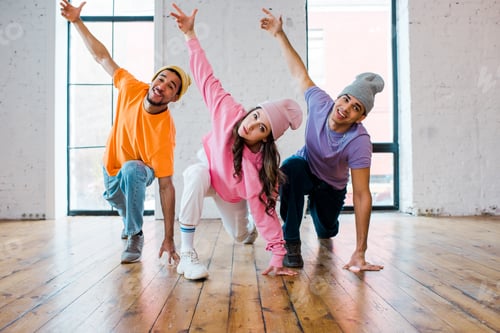 Preview: stylish multicultural men in hats breakdancing with attractive young woman