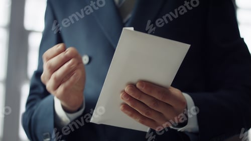 Preview: Hands holding bribe envelope containing euro cash close up. Financial crime.