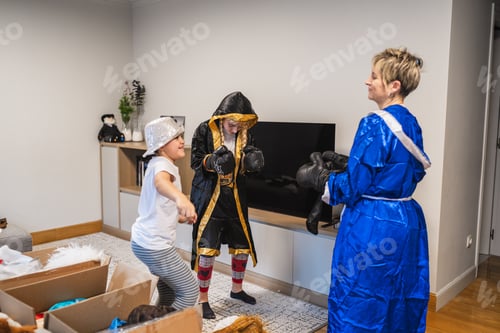 Preview: Mother and children playing dress up with boxing costumes