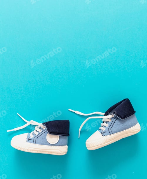Preview: Baby boy shoes on blue color background, copy space