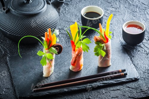 Preview: Fresh spring rolls with soy sauce on black rock