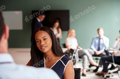 Preview: Businesswoman And Businessman Collaborating On Task Together At Graduate Recruitment Assessment Day