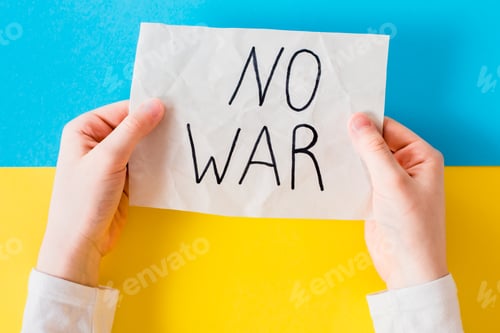 Preview: Children's hands hold a poster with the inscription "no war" on the Ukrainian flag.
