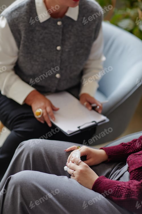 Preview: Female Therapist Supporting Young Adult Woman Grieving