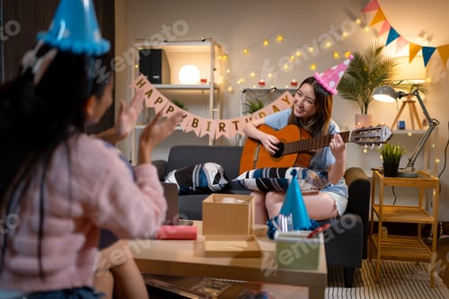Preview: Woman Playing Guitar at Birthday Celebration with Friend