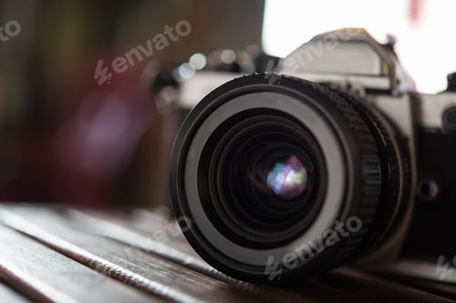 Preview: Vintage film camera on wooden table. Retro style.