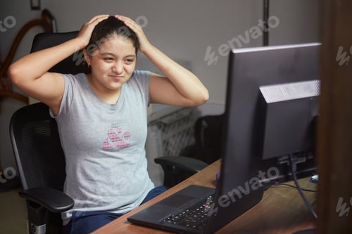 Preview: Young female using the computer in her room