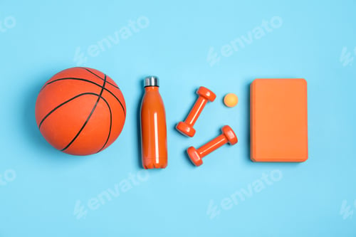Preview: Different sports equipment and water bottle on light blue background, flat lay