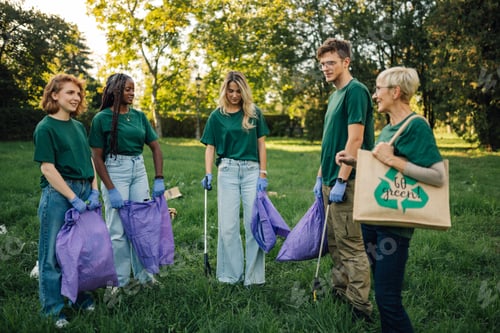 Preview: Group of volunteers picking up trash in the park