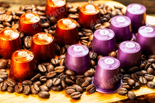 Preview: Espresso coffee capsules or pods and coffee beans on wooden rustic background