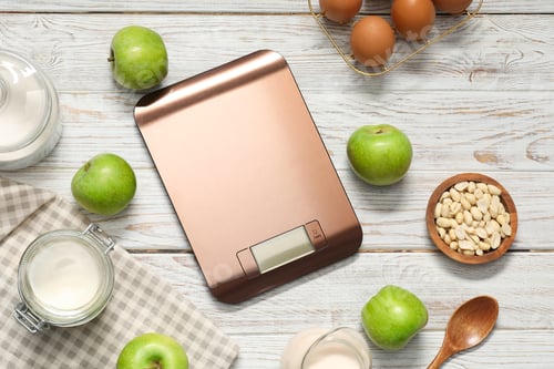 Preview: Electronic kitchen scale and products on white wooden table, flat lay