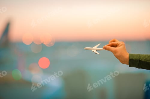 Preview: Close up hand holding an airplane model