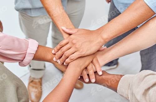 Preview: Closeup shot of a group of unrecognizable people joining their hands together in unity