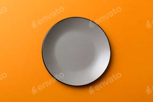 Preview: Top view of isolated of colored background empty round gray plate for food.