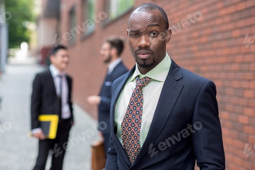Preview: Portrait Of Multi Ethnic Business Team.Three Men Standing Against The Background Of Red Brick Wall