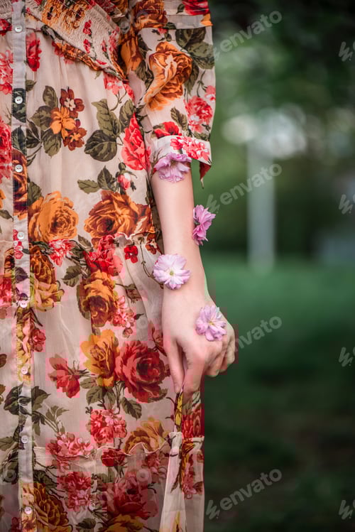 Preview: Woman Wearing Floral Dress with Flowers on Arm