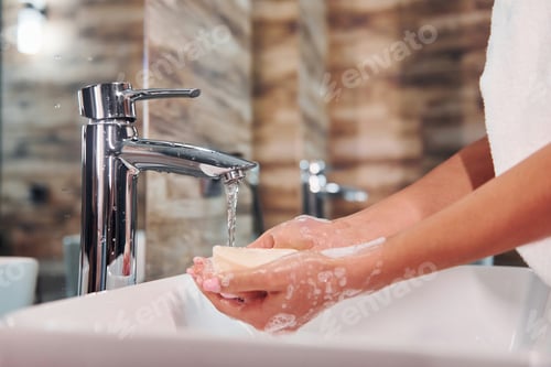 Preview: Close up view of woman that standing in bathroom and washing hands