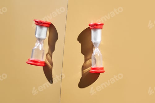 Preview: Dual red-capped sand timers casting shadows on beige background highlighting