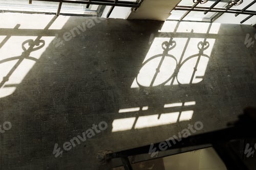 Preview: beautiful shadow on the concrete floor from the bars on the windows