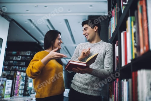 Preview: Positive couple discussing books during choosing interesting literature