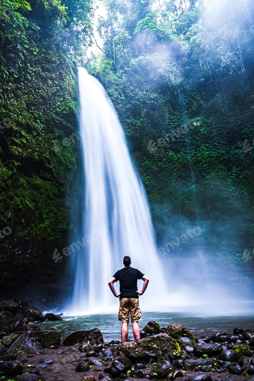 Preview: A man admiring the beautiful waterfall in Bali.