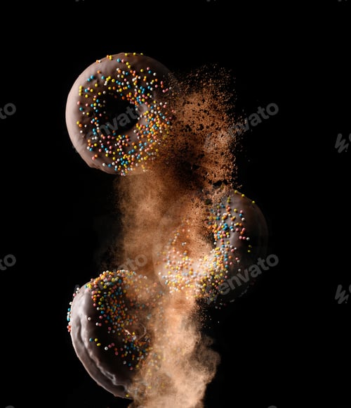 Preview: Chocolate round donuts with multicolored sugar sprinkles levitate in a cloud of brown cocoa