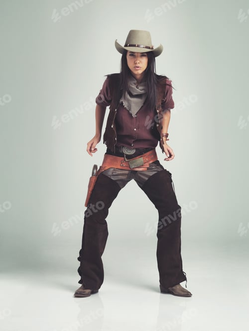 Preview: Im the sheriff around these parts...Full-length shot of an attractive young woman in cowboy attire.