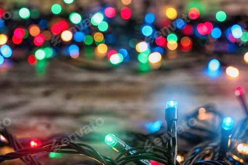Preview: Beautiful bright Christmas lights on table, closeup