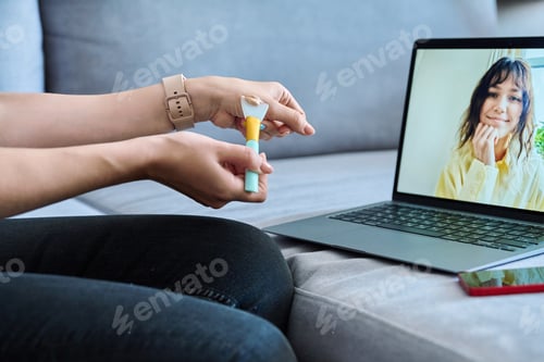 Preview: Video call chat conference, young woman consultation on use, cosmetic mask