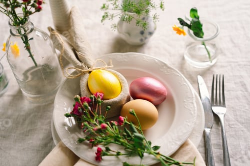 Preview: Happy Easter. Stylish easter eggs on a napkin with spring flowers on white wooden background