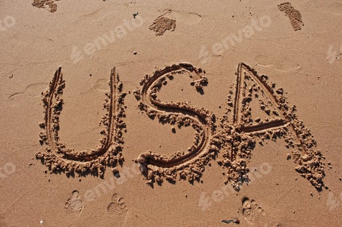 Preview: "USA" written in the sand on the beach