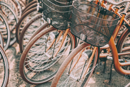 Preview: Close Up Of Wheel Of Bicycles On Parking In City. Sunlight Sunsh