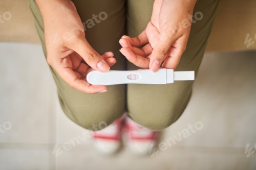 Preview: Happy young latin woman shows positive pregnancy test. Concept, conscious motherhood family planning