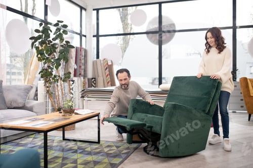 Preview: Man and woman in light sweaters spending time in a furniture shop
