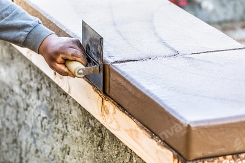 Preview: Construction Worker Using Stainless Steel Edger On Wet Cement Forming Coping Around New Pool