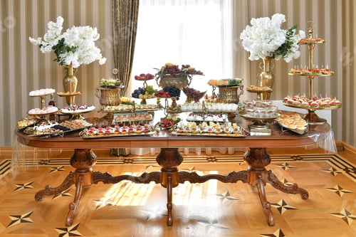 Preview: Elegant buffet table with assorted desserts and fruits in a luxurious setting